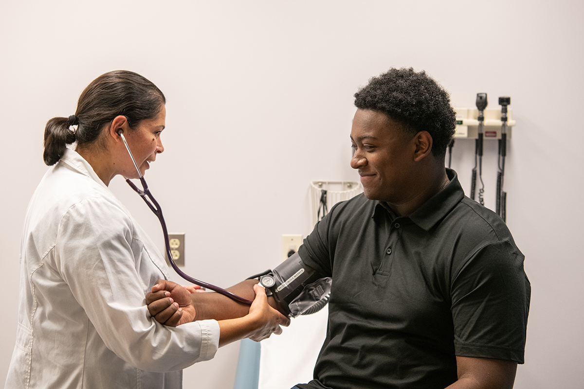 a nurse practitioner examines an adolescent